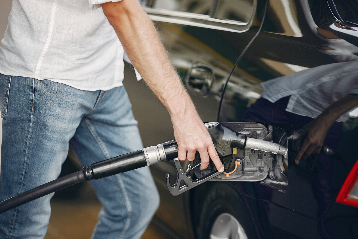 handsome-man-pours-gasoline-into-tank-car