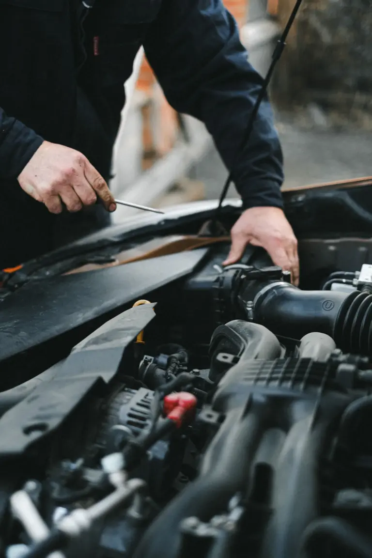 Mobile technician draining contaminated fuel from a petrol car