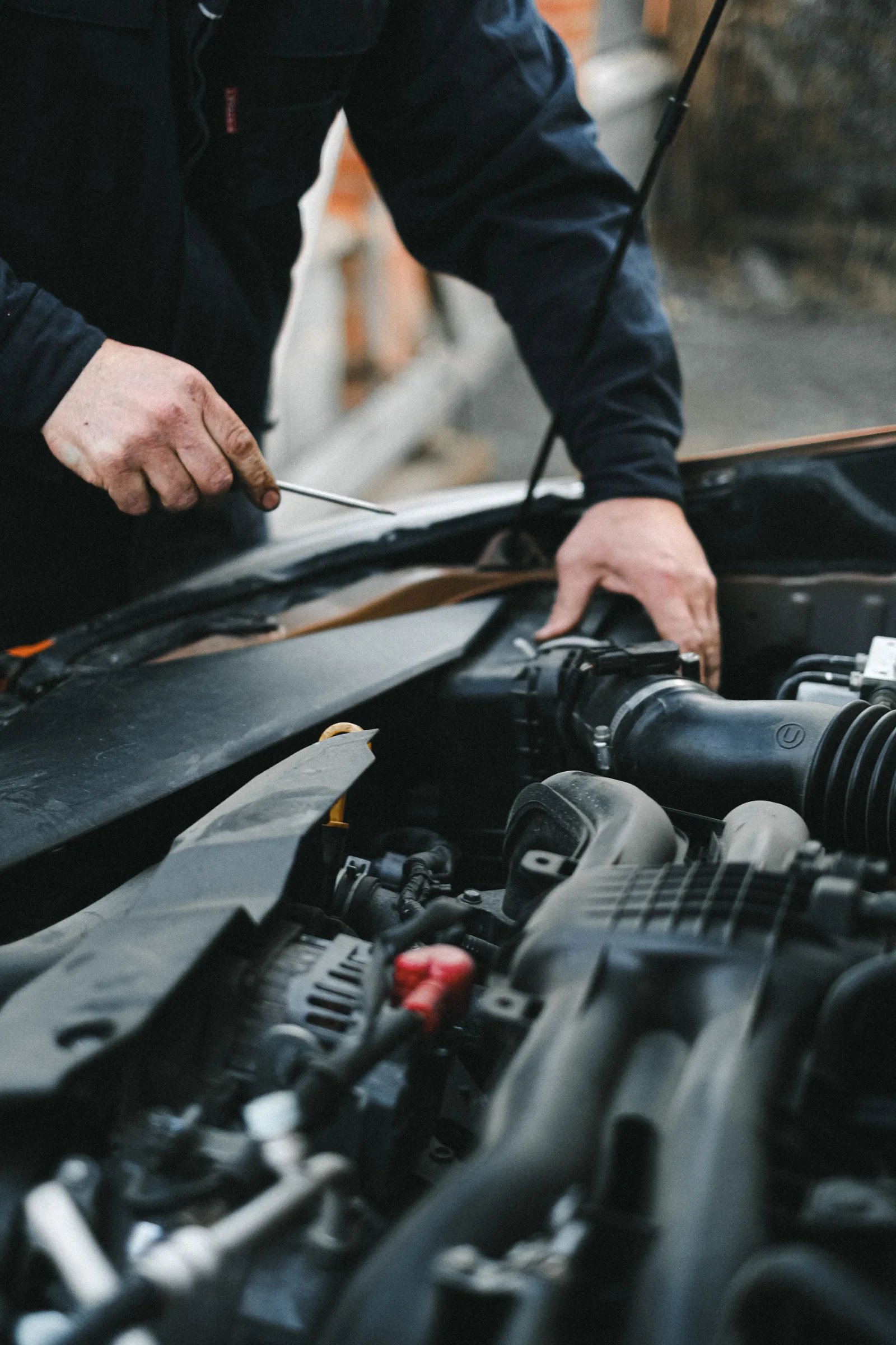 Mobile technician draining contaminated fuel from a petrol car
