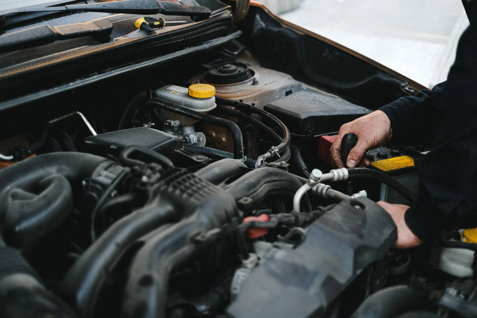 Technician draining contaminated fuel from a company fleet vehicle